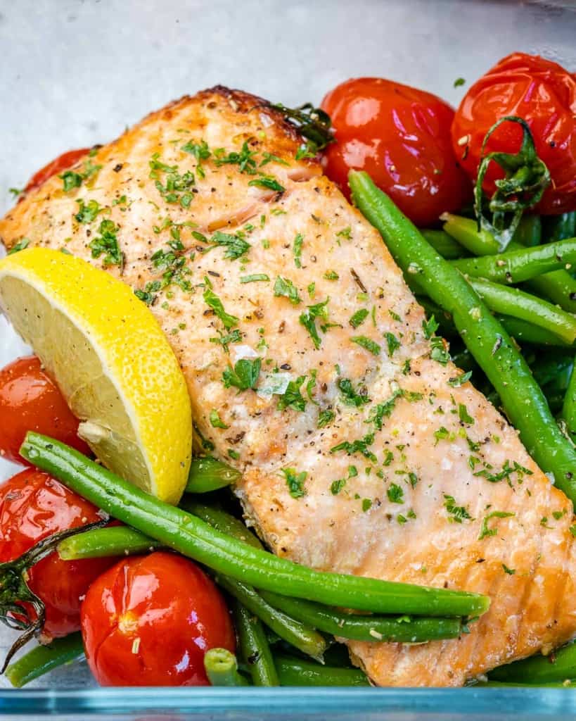 One salmon fillet with green beans, lemon wedge, and tomatoes