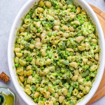 top view of green mac and cheese in a white dish