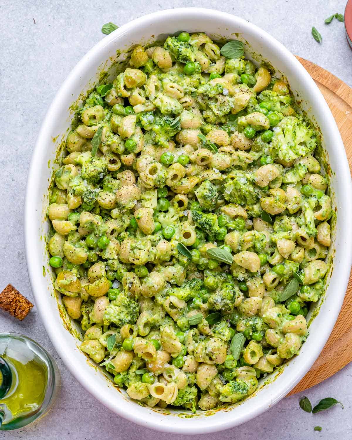 top view of green mac and cheese in a white dish