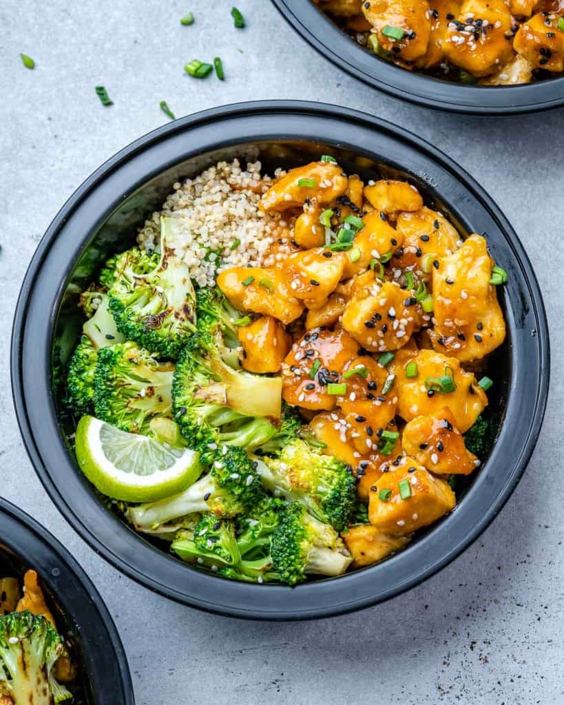 top view of honey chicken with broccoli and quinoa in a meal prep bowl