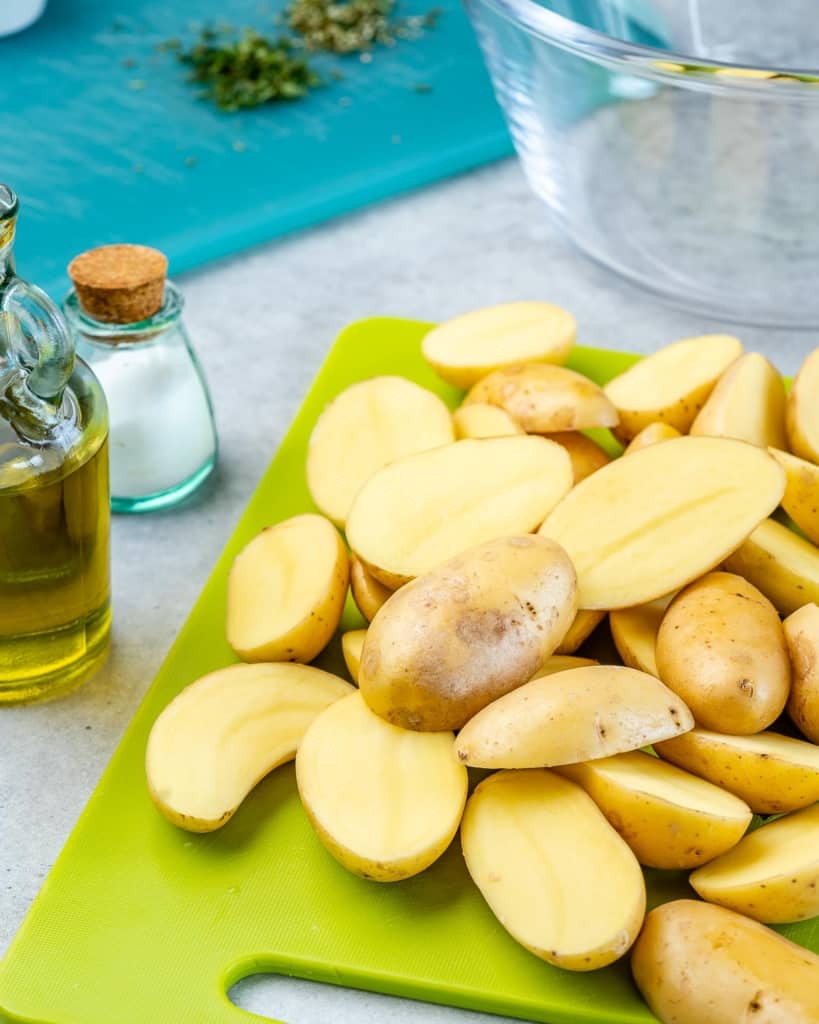 sliced yellow baby potatoes on a cutting board