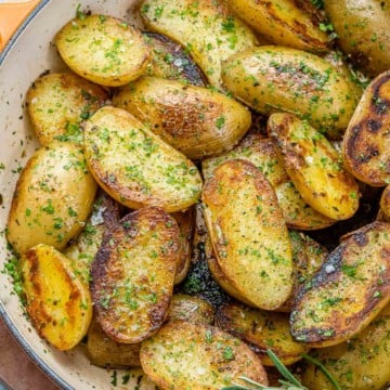 top view of roasted potatoes in an orange skillet