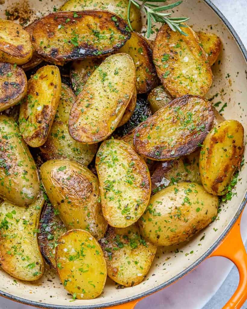 top view roasted baby potatoes in an orange skillet