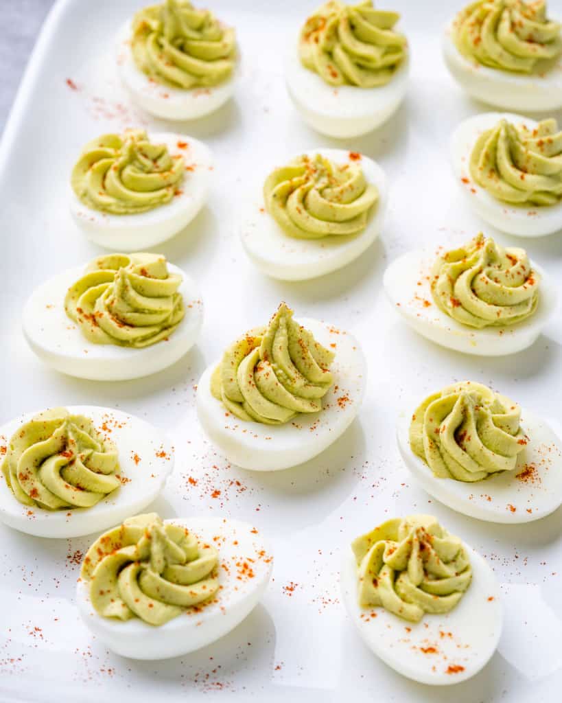 side shot of deviled eggs on a white dish
