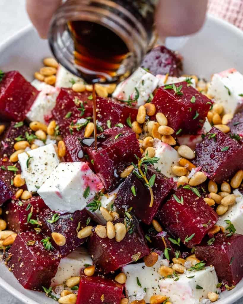 Close view of beet salad in bowl with balsamic vinegar