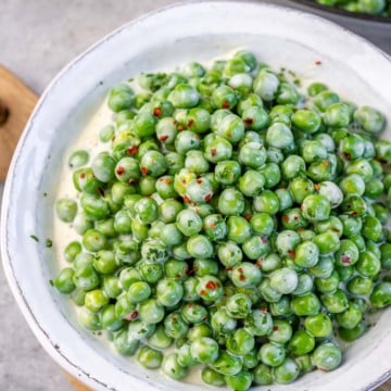 creamed peas in a white bowl