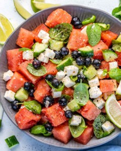 Top view of salad in bowl with lime wedges