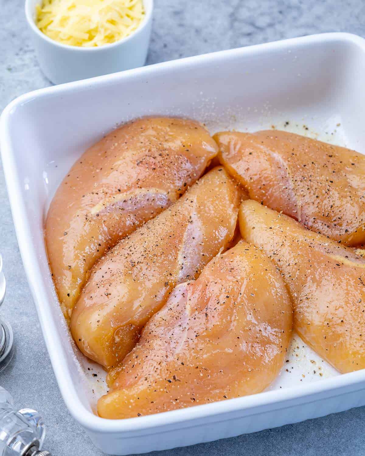Raw chicken in white dish