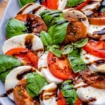 Close image of caprese salad on plate with balsamic drizzle