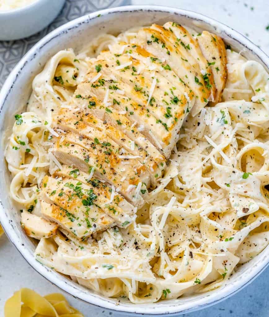 top view chicken alfredo in a white bowl