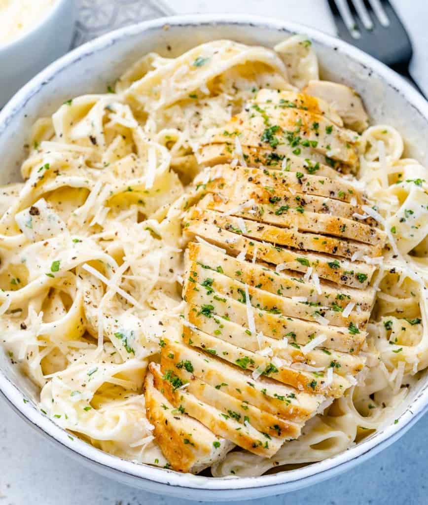 top view chicken alfredo in a white bowl