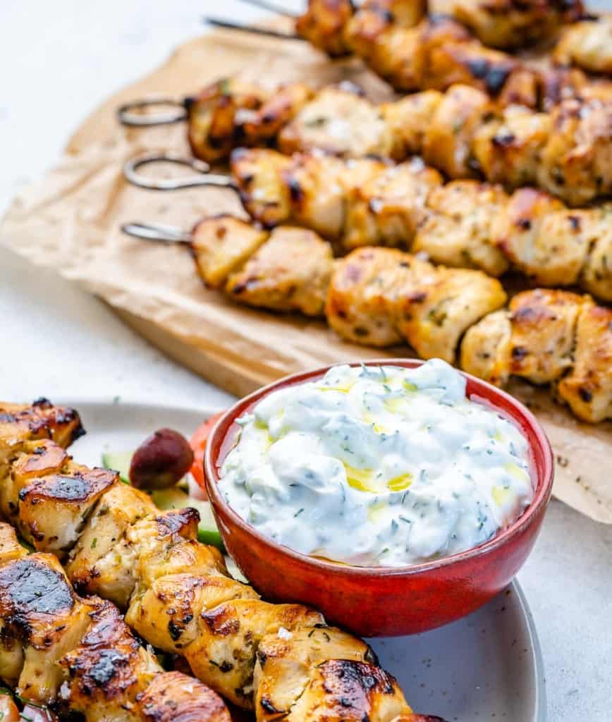 front view of Greek yogurt sauce in bowl with grilled chicken