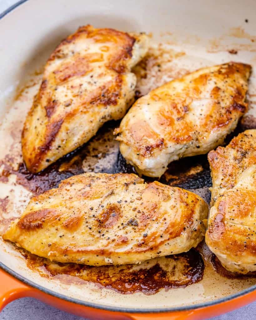 Four cooked chicken breasts