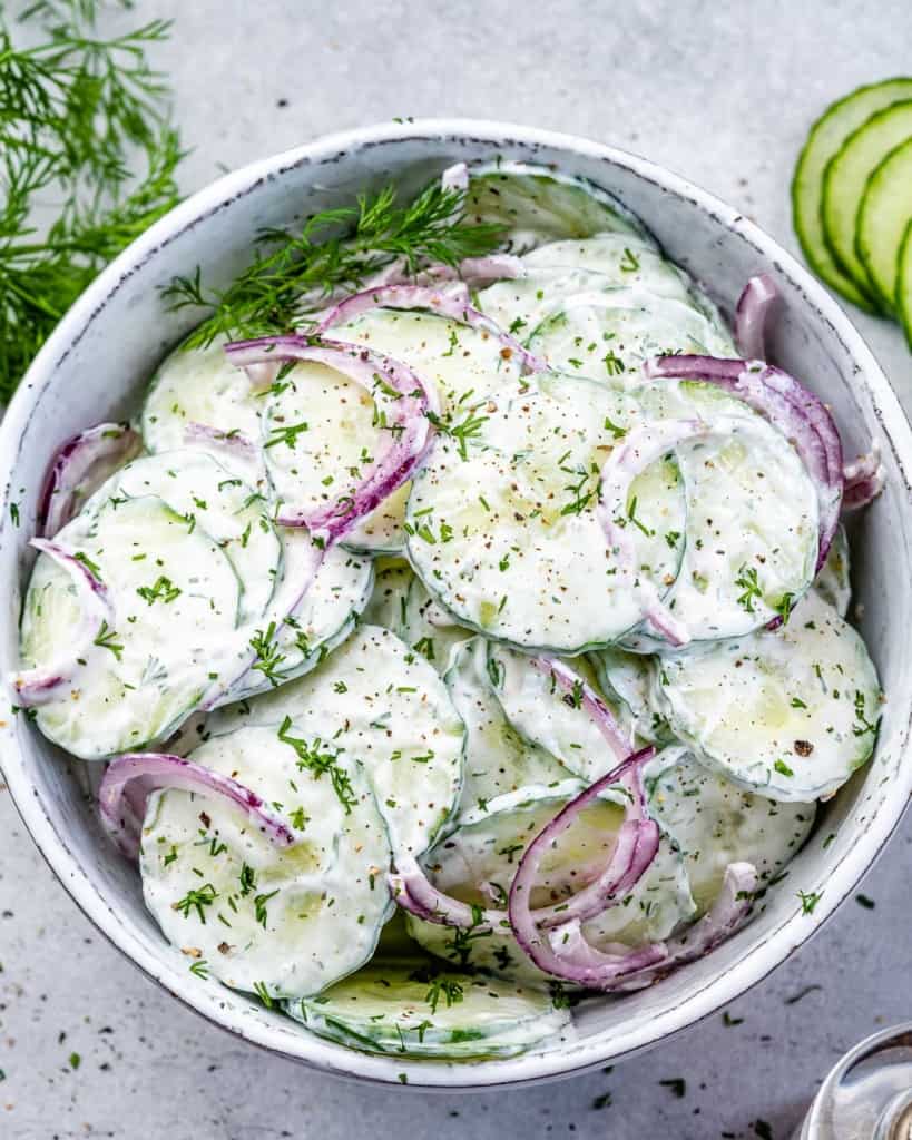 top view cucumber salad in white bowl