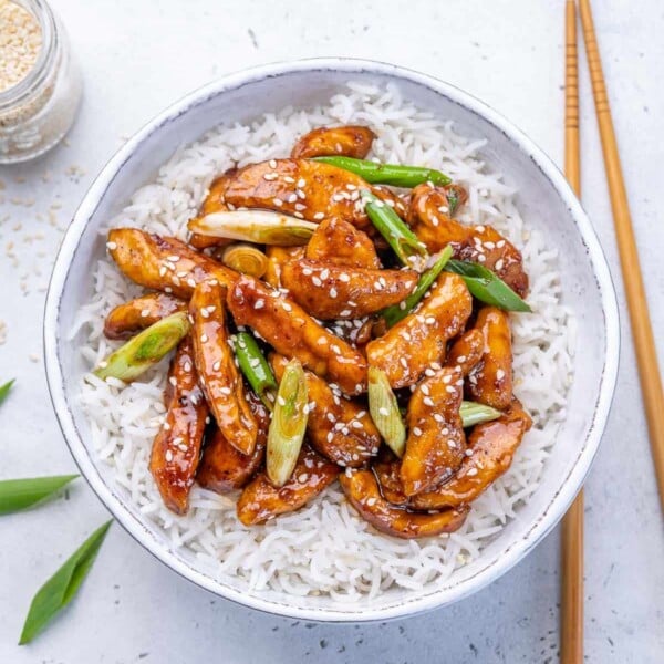 top view asian chicken over a bed of rice in a bowl
