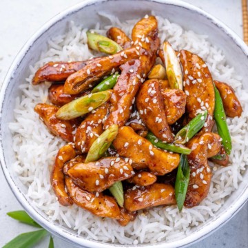 close up top view of mongolian chicken serve over a bowl of rice