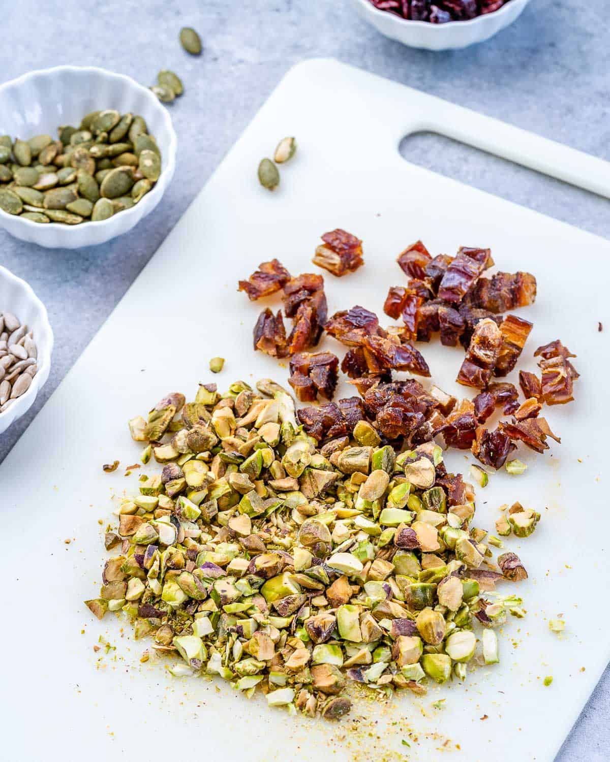 Oatmeal Granola Bars from Scratch 4 Close-up view of roughly chopped Medjool dates and pistachios, highlighting the freshness and texture of the individual ingredients before mixing.