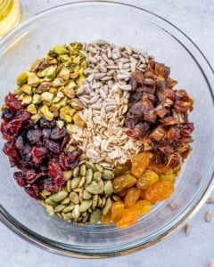 chopped up granola ingredients in a bowl before mixing
