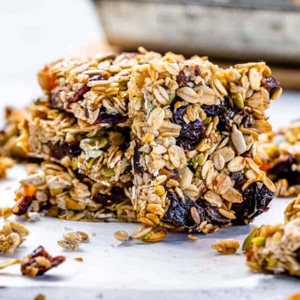oatmeal bars made with oats dried fruits, and nuts, stacked over each other.