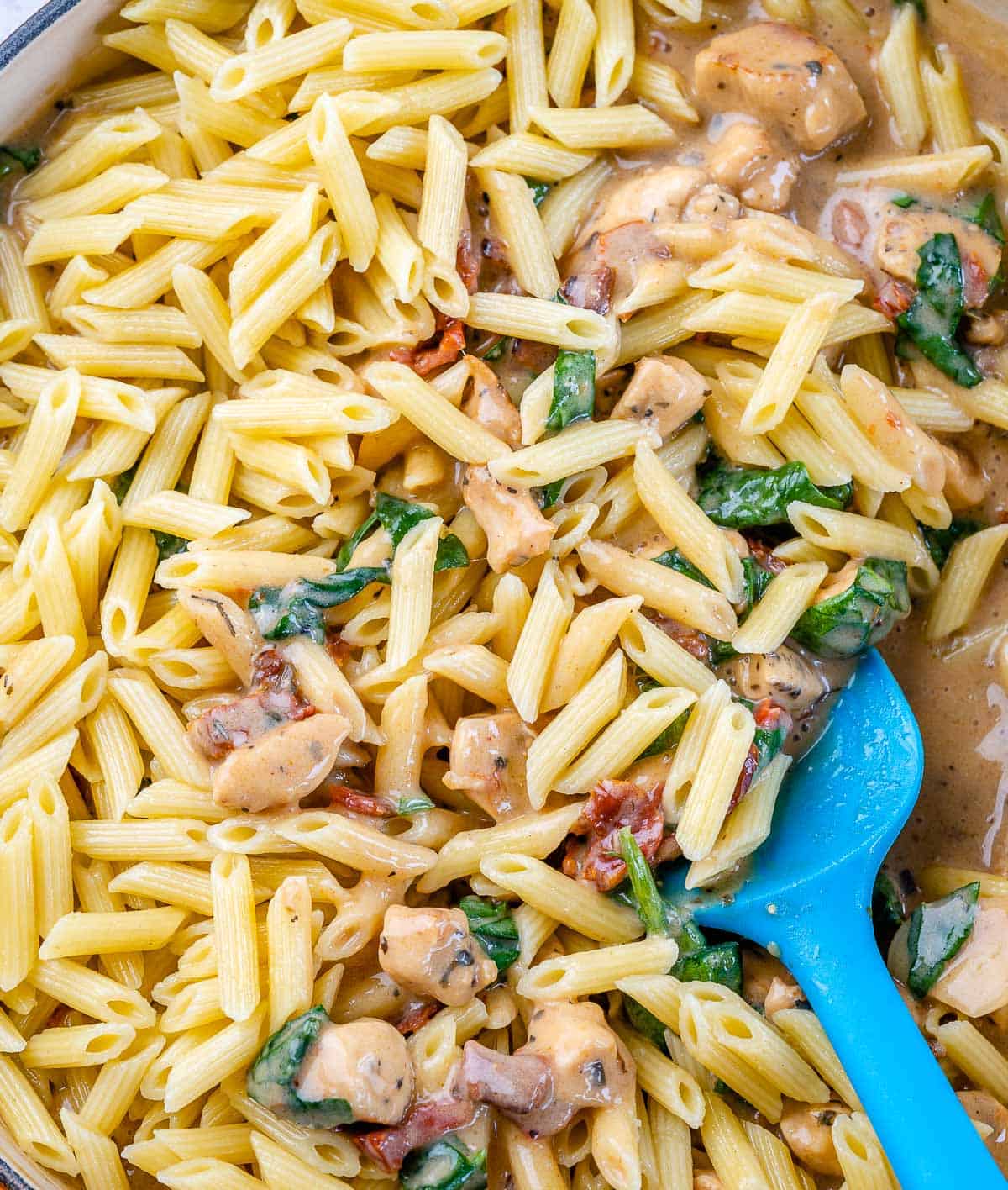 cooked pasta added to the creamy chicken sauce mix.