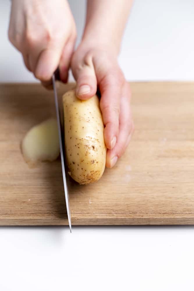 slicing a potato with knife