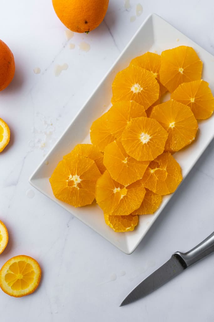 A platter of multiple slices of oranges.