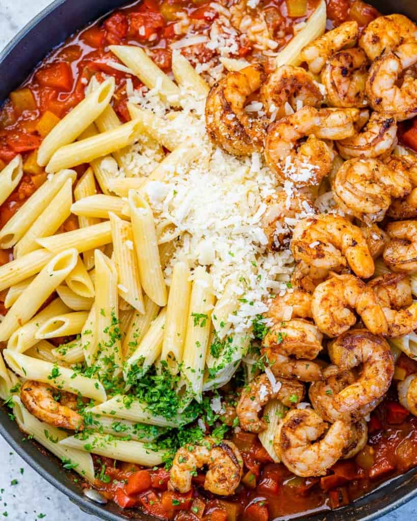 top view of pasta and shrimp over tomato sauce