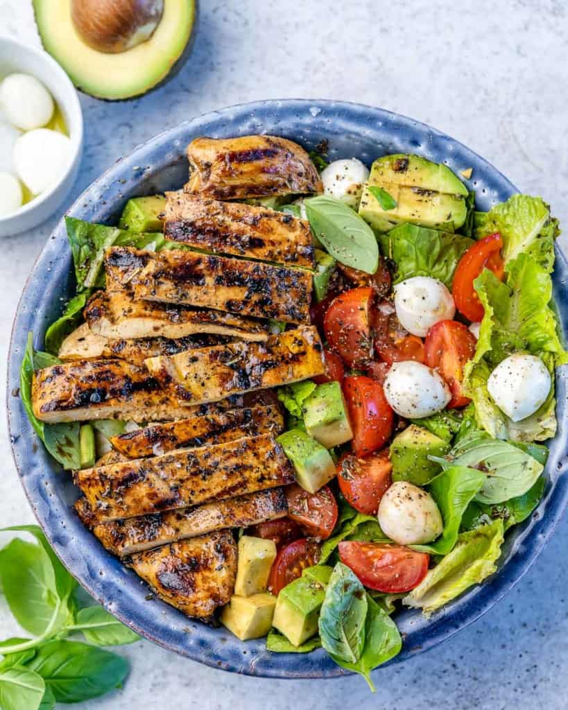 top view grilled chicken over caprese salad 