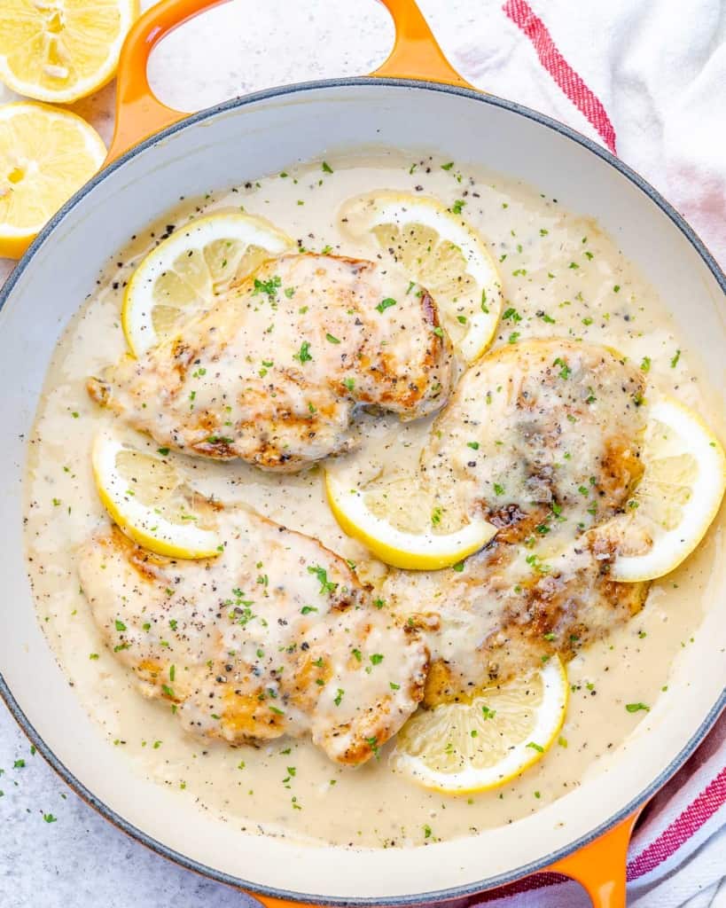 top view of creamy chicken breast in an orange pan