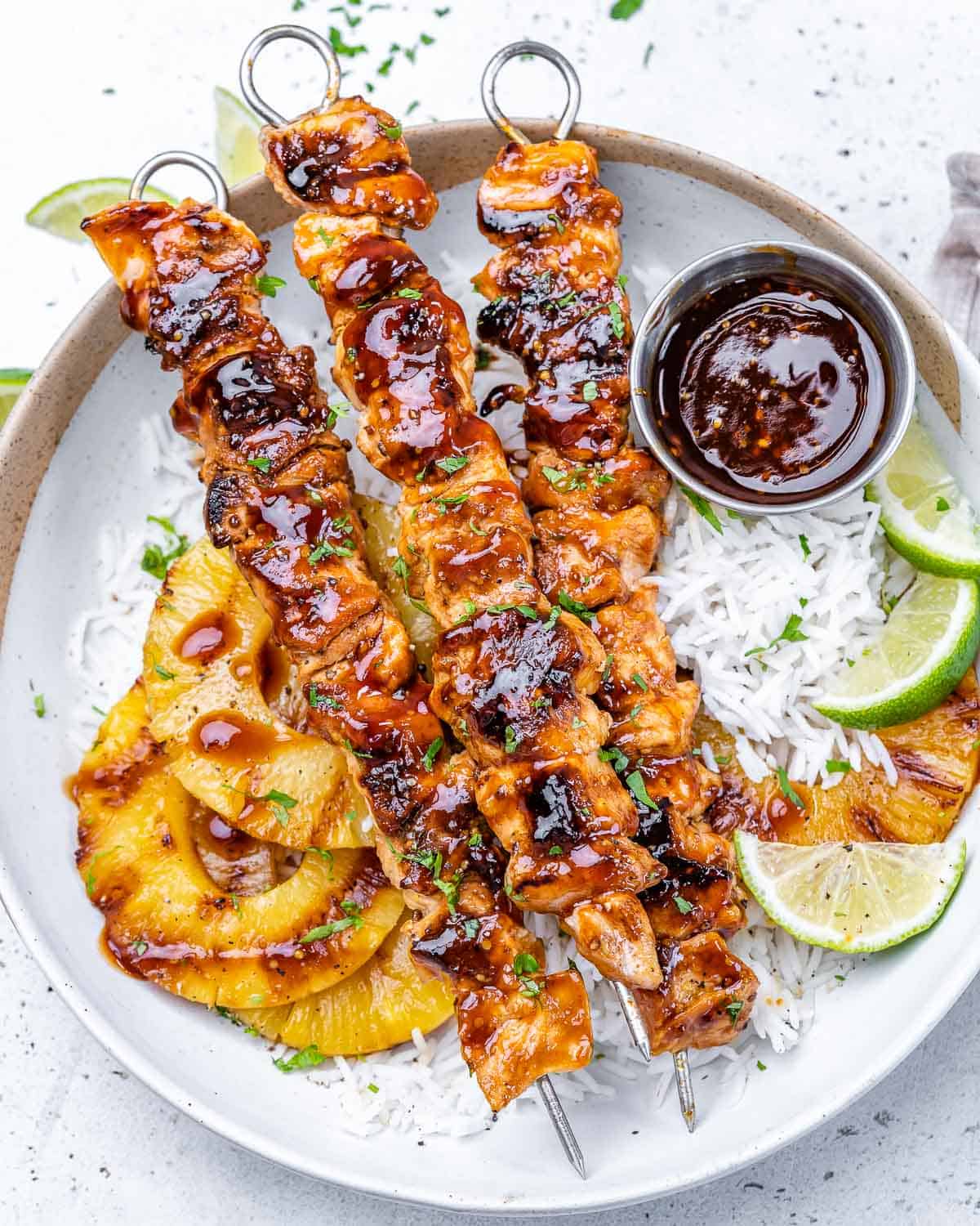 top view 3 chicken skewers with grilled pineapple and rice