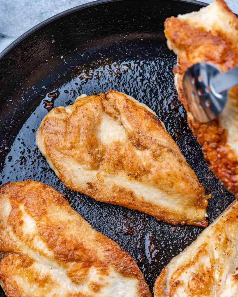 chicken breast cooked in black skillet