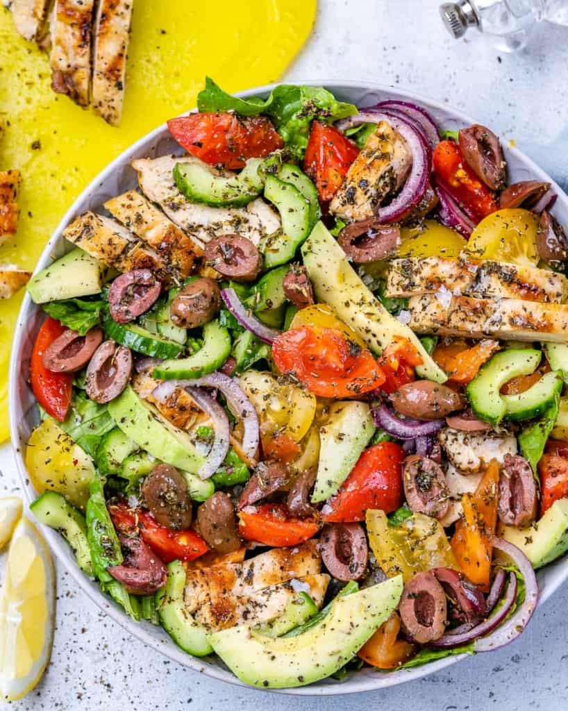 top view of salad with chicken breast slices  in white bowl 