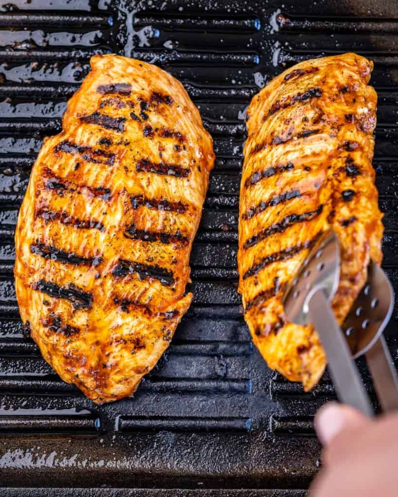 two grilled chicken breast on a grill pan