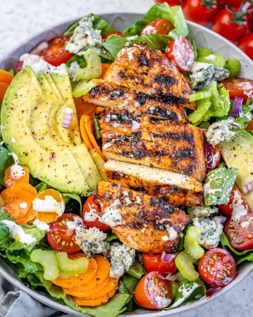 close up grilled chicken salad with avocado and blue cheese 