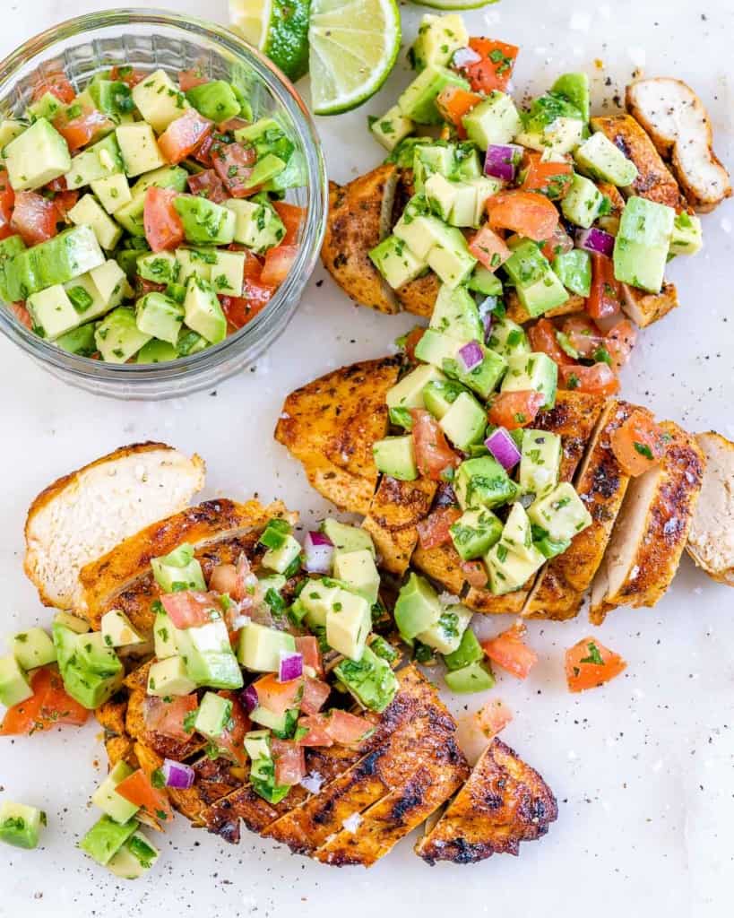 top view sliced chicken breast topped with avocado salsa