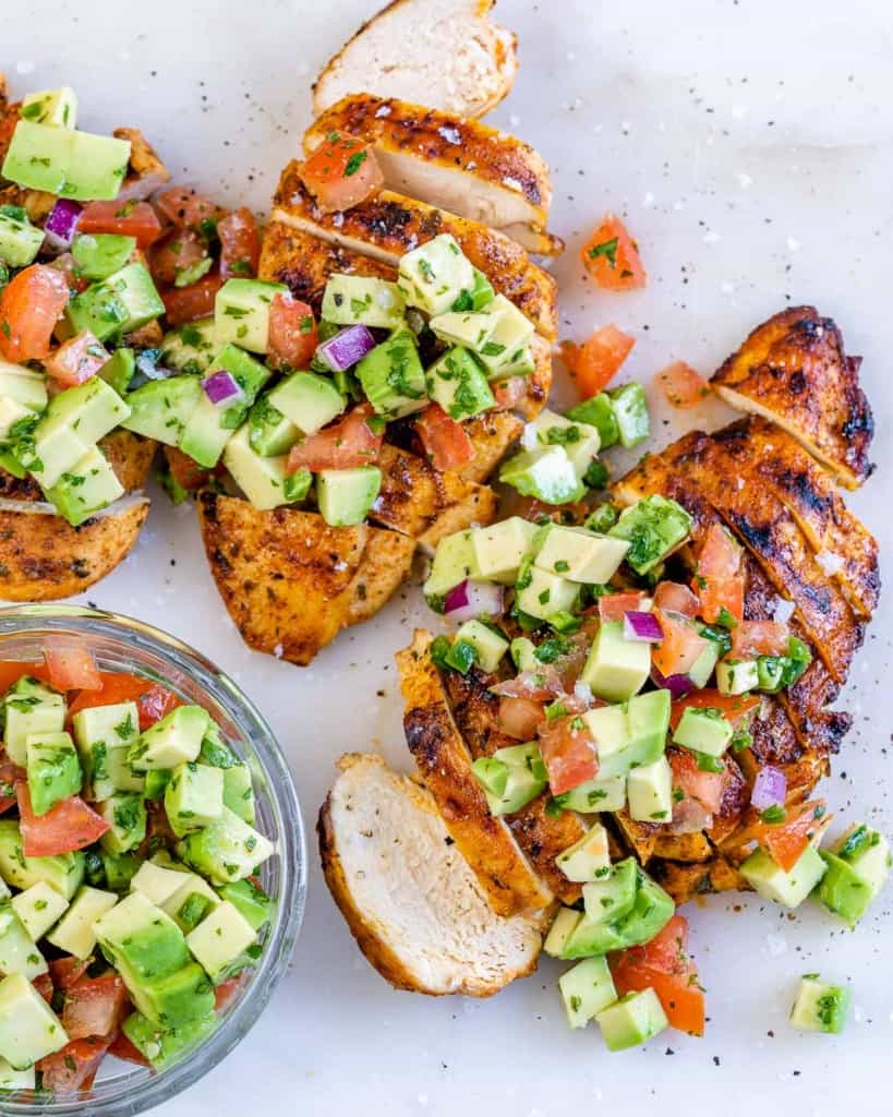 top view chicken breast sliced with avocado salsa