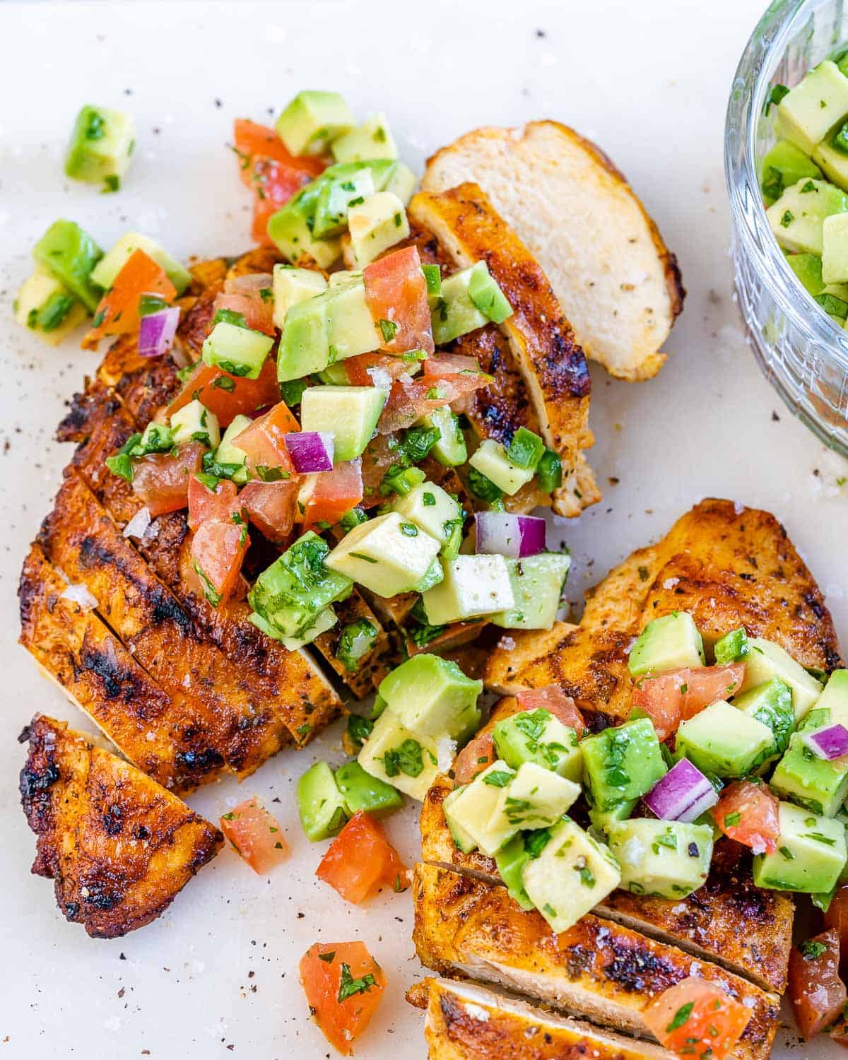 sliced grilled chicken topped with avocado salsa.