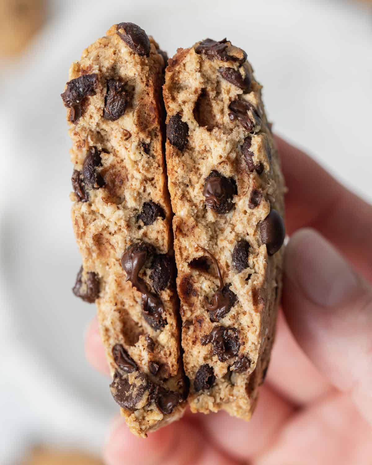 hand holding a cookie cut in half.