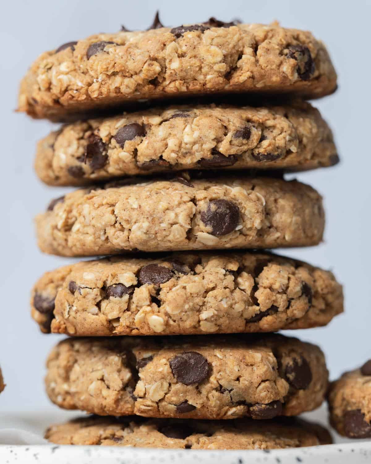 6 baked cookies stacked over each other on a flat surface.