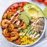top view shrimp burrito with avocado, cauliflower rice, tomatoes, and corn