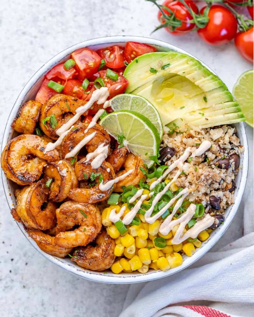 top view shrimp burrito with avocado, cauliflower rice, tomatoes, and corn