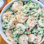 top view creamy shrimp salad with peas and celery in a white bowl