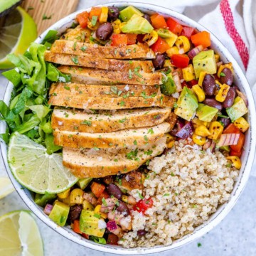 top view taco grilled chicken in a white bowl with salad and quinoa