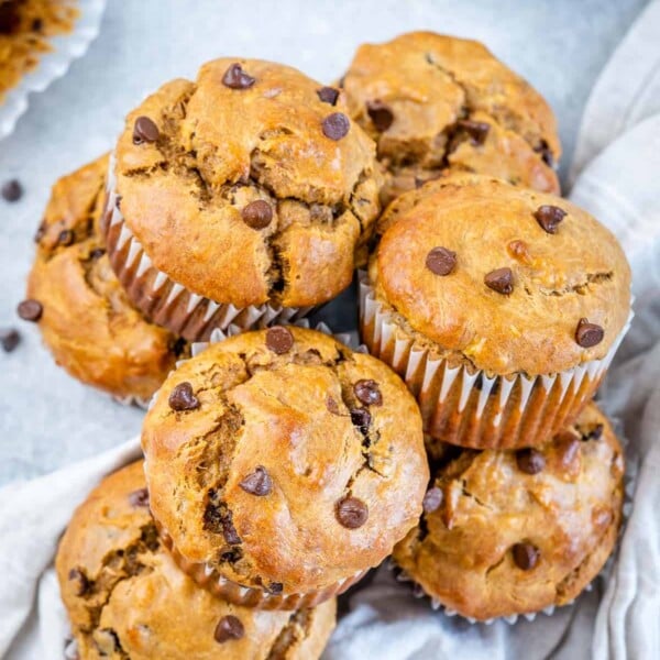 stacks of peanut butter muffins made with chocolate chips next to each other.