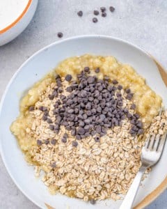 mashed banana, oatmeal, and chocolate chips in a bowl to be mixed