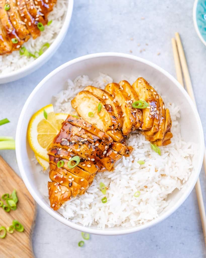 top view of teriyaki chicken with rice in a white bowl