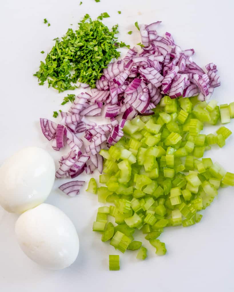 eggs, red onion, celery, and parsley for cauliflower potato salad
