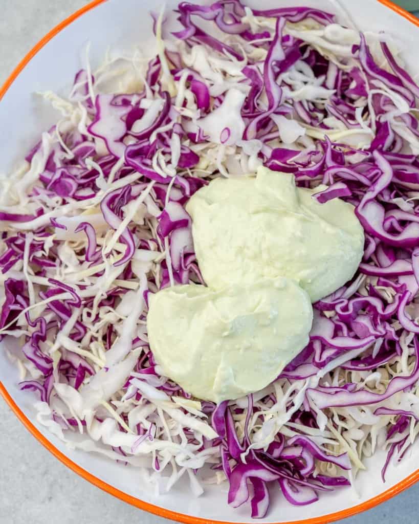 avocado yogurt sauce over shredded cabbage