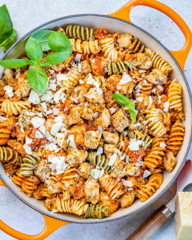 top view of chicken pasta in an orange skillet