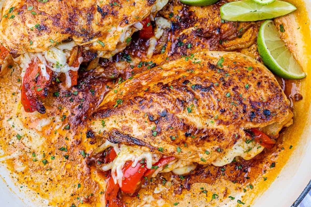 top view of chicken breast in pan with lime garnishes